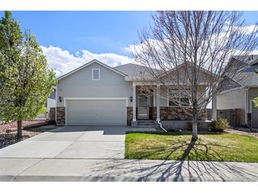 Charming single Gathering home with a two car garage, landscaped yard, and covered front porch at 401 Clubhouse Dr, Fort Lupton, CO 80621