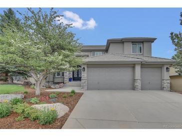 Charming two-story home boasts a three-car garage, well-maintained landscaping, and mature shade tree in the front yard at 877 Eldorado Dr, Superior, CO 80027