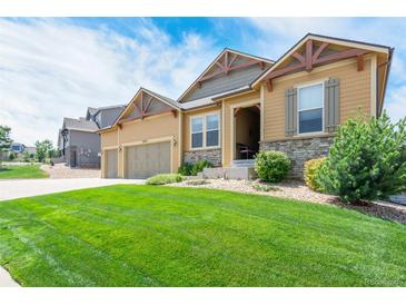 Two-story house with a landscaped lawn and attached garage at 3995 Manorbrier Cir, Castle Rock, CO 80104