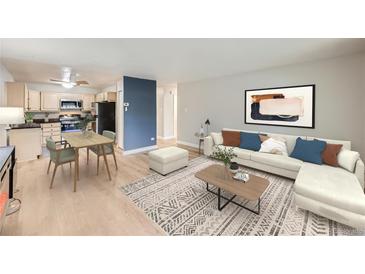 Bright living room featuring wood floors, neutral paint, an area rug, dining table, and modern furniture at 675 S Alton Way # 7A, Denver, CO 80247