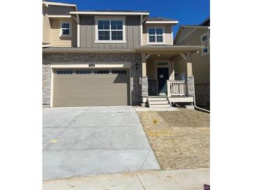 Charming two-story home showcasing stone accents, neutral paint and a two-car garage at 6739 Juniper Dr, Thornton, CO 80602