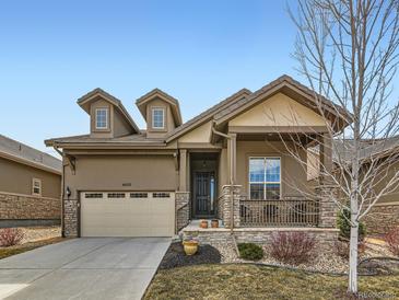 Charming home featuring a two-car garage, stone accents, dormer windows, and covered porch at 4420 White Rock Dr, Broomfield, CO 80023