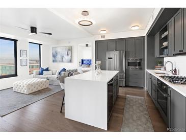 Modern kitchen with stainless steel appliances and an island at 1750 Wewatta St # 1521, Denver, CO 80202