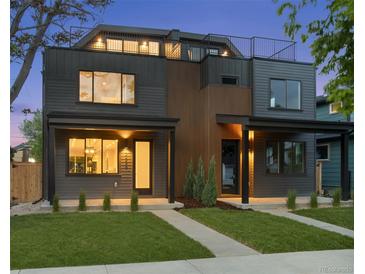 Modern two-story home boasting a rooftop deck and sleek contemporary design with a manicured lawn at 2450 S Cherokee St, Denver, CO 80223
