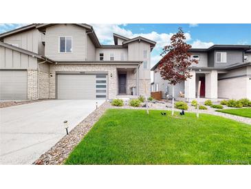 Charming two-story home featuring a two-car garage, well-manicured lawn, and tasteful landscaping at 3625 Silver Rock Cir, Castle Rock, CO 80104