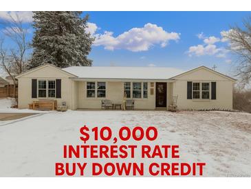 Charming ranch-style home with a well-maintained front yard and snow covered lawn at 3865 Independence Ct, Wheat Ridge, CO 80033