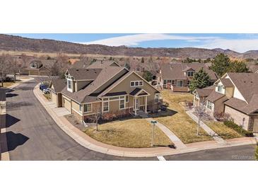 Charming two-story home with a well-maintained lawn, mature trees, and mountain views in a friendly neighborhood at 10441 W Remington Dr, Littleton, CO 80127