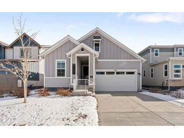 Charming craftsman style home with gray siding and a two-car garage at 838 N Yantley St, Aurora, CO 80018