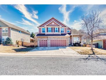 Beautiful two-story home featuring stone accents, three car garage, and meticulous landscaping at 22678 E Lake Pl, Centennial, CO 80015