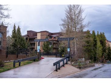 Powderhorn residence featuring brick accents, trees, and an inviting entrance at 765 Columbine St # C203, Breckenridge, CO 80424