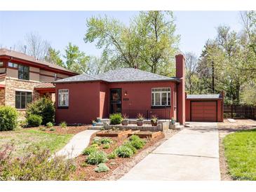 Charming brick home featuring a lush front yard and inviting curb appeal at 650 Kearney St, Denver, CO 80220