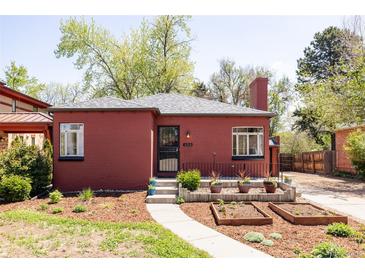 Charming red brick home featuring a walkway, well-kept garden, and a welcoming front entrance at 650 Kearney St, Denver, CO 80220