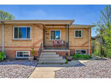Charming brick home featuring a cozy front porch and well-maintained landscaping at 3818 W 25Th Ave, Denver, CO 80211