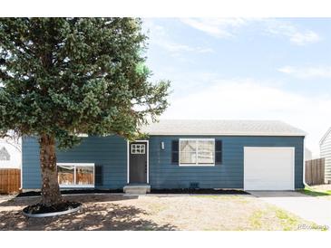 Inviting single-story home features a well-manicured lawn, new exterior paint, and attached one-car garage at 10024 Holland Ct, Broomfield, CO 80021