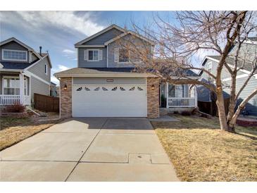 Charming two-story home with a brick-accented garage and well-manicured lawn in a friendly neighborhood at 1188 Mulberry Ln, Highlands Ranch, CO 80129