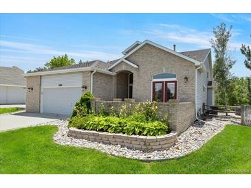 Charming single-Gathering home showcasing well-maintained landscaping, a brick exterior, and an attached two car garage at 12671 Home Farm Ln, Westminster, CO 80234