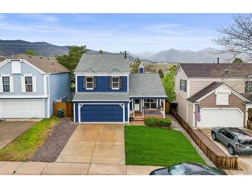 Charming two-story home with a well-manicured lawn and mountain views at 7927 Elmwood St, Littleton, CO 80125