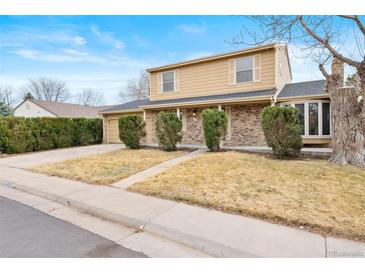 Inviting two-story home featuring brick accents, a well-maintained yard, and an attached two-car garage at 8610 E Eastman Ave, Denver, CO 80231