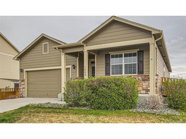 Charming single-Gathering home features a manicured front yard and an attached two-car garage at 1888 Ruby Ct, Brighton, CO 80603
