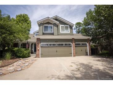 Lovely two-story home with a three-car garage, brick accents, and a well-maintained lawn and garden at 10856 Parker Vista Ln, Parker, CO 80138