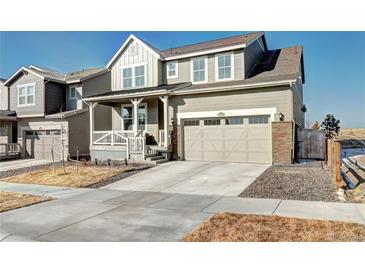Charming two-story home features a covered front porch and attached two-car garage at 13437 Starhawk Ln, Parker, CO 80134