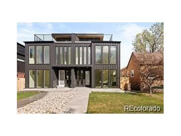 Modern two-story home with large windows, sleek lines, rooftop deck, and well-maintained landscaping at 4238 Zuni St, Denver, CO 80211