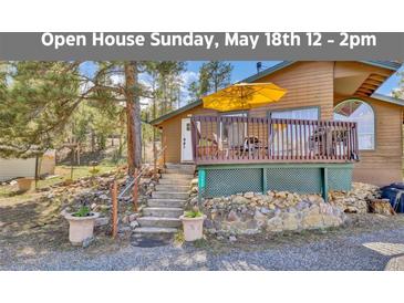 Charming exterior of home with inviting deck and landscaped yard at 11798 Ridge Rd, Golden, CO 80403