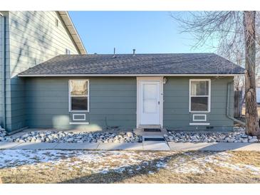 Ranch style home with gray exterior, landscaping, and a walkway at 2131 Coronado Pkwy # A, Denver, CO 80229