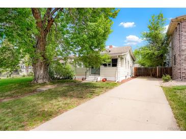 Charming single-Gathering home featuring a large tree and long driveway on a sunny day at 1160 S Steele St, Denver, CO 80210