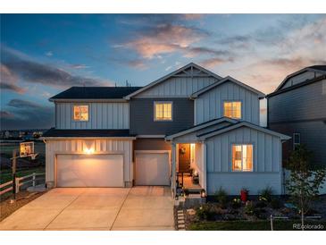 Charming two-story home features a two-car garage, landscaped front yard, and inviting entrance at twilight at 17851 Herrera Dr, Parker, CO 80134
