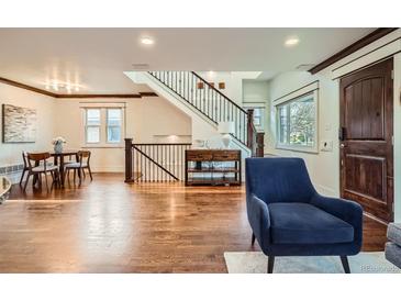Spacious living room featuring hardwood floors, staircase, and dark wood accents throughout at 2039 S Corona St, Denver, CO 80210