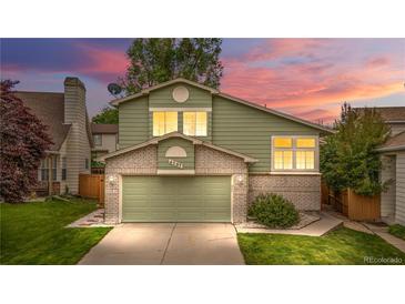 Charming two-story home with well-maintained lawn, brick accents, and an attached two-car garage at 4707 N Bearlily Way, Castle Rock, CO 80109