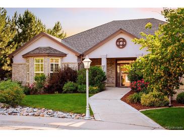 Charming home with a brick facade, inviting walkway, manicured lawn, and mature landscaping at 3231 Oak St, Wheat Ridge, CO 80033