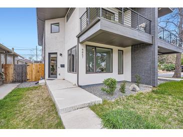 Contemporary home with a modern exterior, balcony, and manicured landscaping at 4457 Wyandot St, Denver, CO 80211