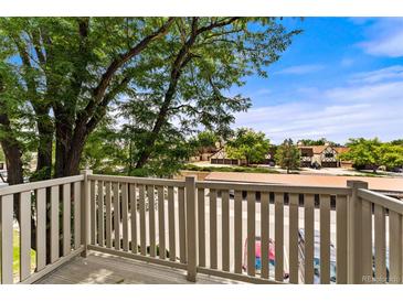 View from balcony shows trees, parking lot and neighboring buildings at 7335 E Quincy Ave # 303, Denver, CO 80237