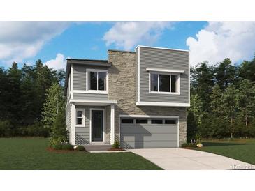 Modern two-story home featuring a stone facade, gray siding, and an attached two-car garage at 11217 Mount Emma Dr, Englewood, CO 80112