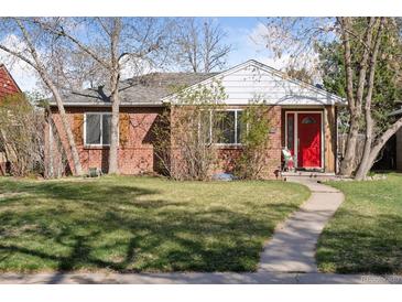 Charming brick ranch home with a well-manicured lawn and a vibrant red front door at 1580 Quince St, Denver, CO 80220