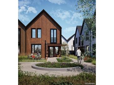 Modern two-story home boasts dark trim, wood siding, stylish landscaping, and an inviting front porch at 5754 W 92Nd Ave, Westminster, CO 80031