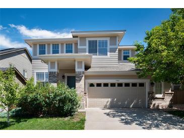 Beautiful two-story home with a two car garage, manicured lawn, brick accents and attractive landscaping at 3466 Craftsbury Dr, Highlands Ranch, CO 80126