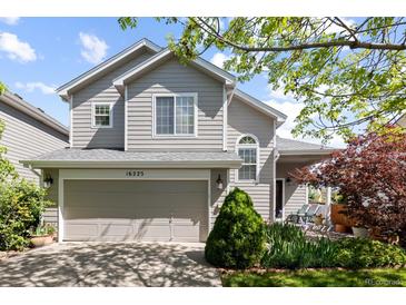 Charming two-story home featuring a well-manicured front yard and an attached two-car garage in a suburban neighborhood at 16225 Peregrine Dr, Parker, CO 80134