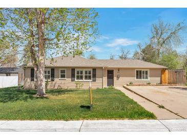Charming one-story home featuring a well-manicured lawn and neutral siding at 6528 S Louthan St, Littleton, CO 80120