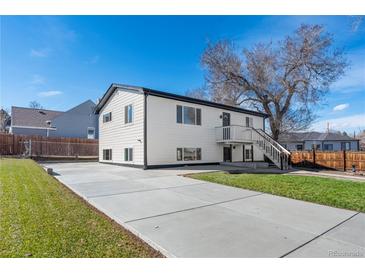 Charming home with a large driveway, manicured lawn, and a well-maintained white exterior at 111 Wolff St, Denver, CO 80219