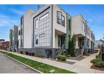 Modern townhome featuring multi-tone gray and white facade, brick accents, and landscaping at 3444 Navajo St # 10, Denver, CO 80211