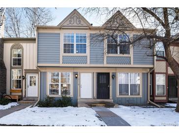 Two-story townhome with gray siding and white door at 1711 S Blackhawk Way # D, Aurora, CO 80012