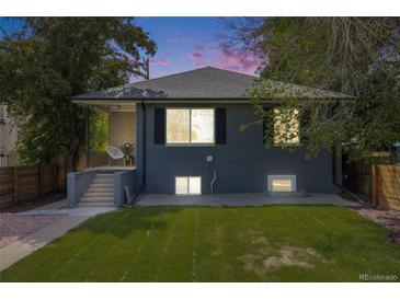 Charming home with a well-maintained lawn and inviting front porch at 1765 Xenia St, Denver, CO 80220