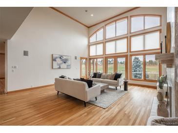 Bright living room with high ceilings, large windows, hardwood floors, and modern neutral furniture at 101 Glenmoor Ln, Cherry Hills Village, CO 80113