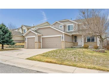 Charming two-story home with a two car garage and well-maintained front lawn at 4579 S Jebel Ct, Centennial, CO 80015