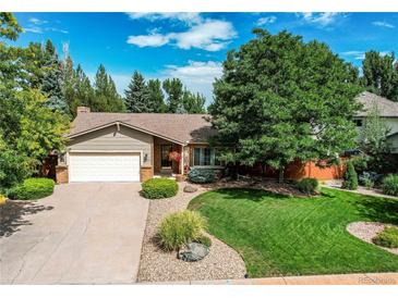 Charming single-story home with a well-manicured lawn and mature landscaping at 20855 E Lyttle Dr, Parker, CO 80138