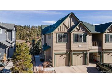 Inviting two-story townhome featuring a two-car garage and well-maintained landscaping at 31101 Black Eagle Dr # 202, Evergreen, CO 80439