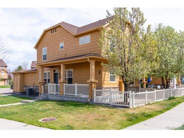 Charming two-story home with a manicured lawn, white picket fence, and inviting front porch at 3760 Ute Mountain Trl, Castle Rock, CO 80109